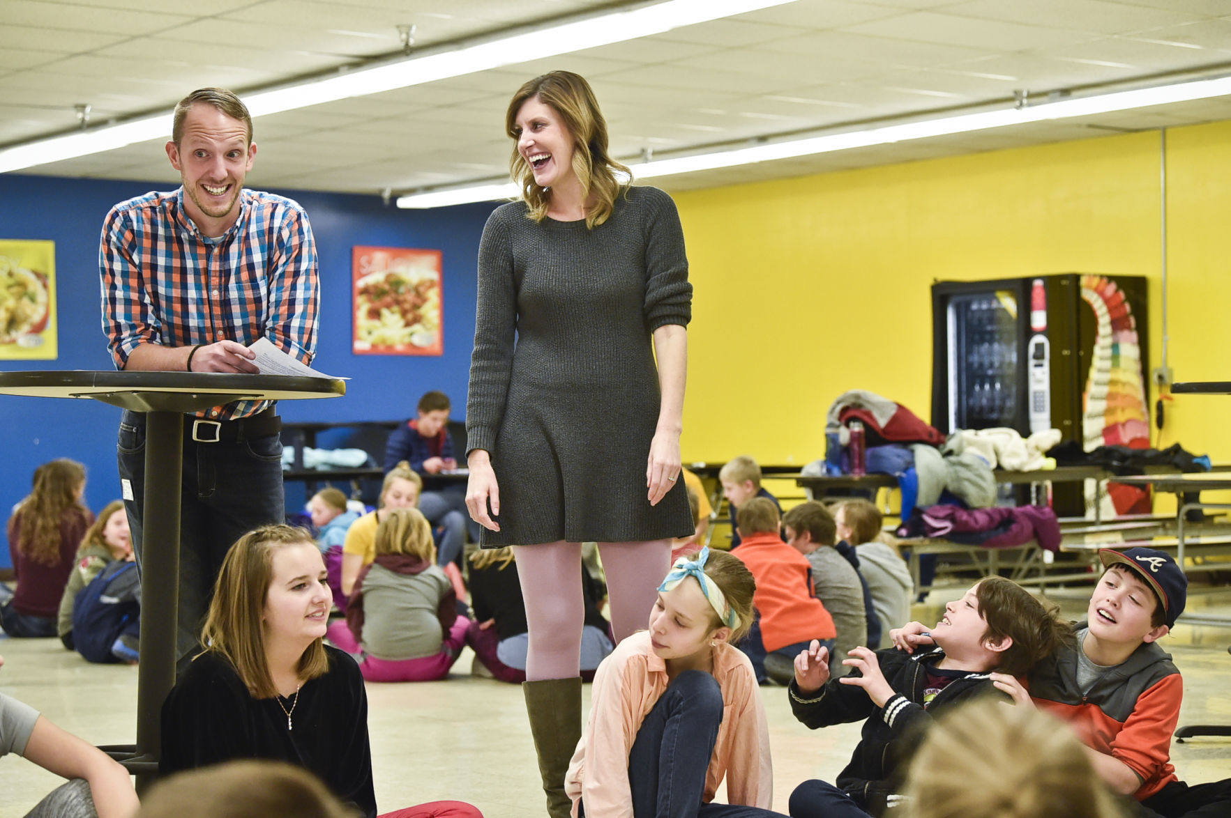 James Buscher, left, and Christine Sieminski jokes with student Thursday.